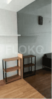 A hallway with shelves and wooden flooring.