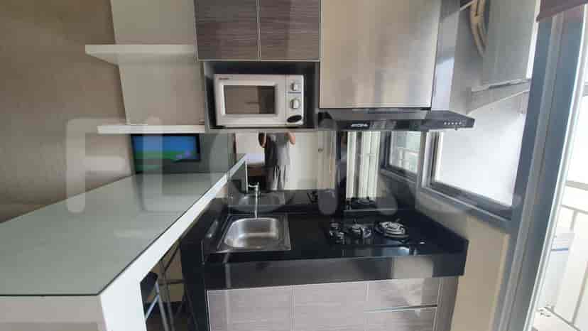 Compact kitchen with appliances and a small workspace.