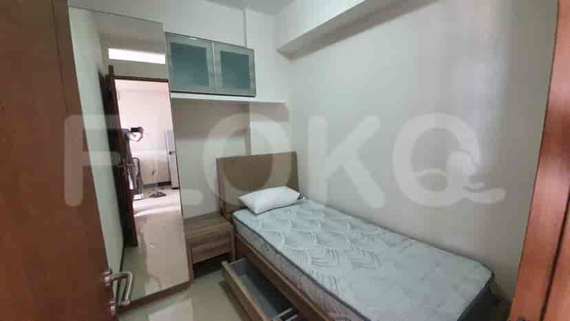 A bedroom with a single bed, wardrobe and mirror.