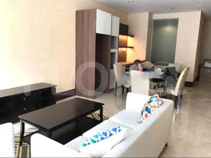 A combined living and dining space featuring a white sofa, a dining table, and marble flooring.