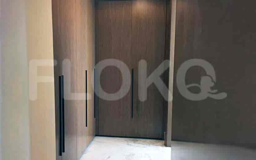 A modern closet with wooden doors, showing ample storage space.