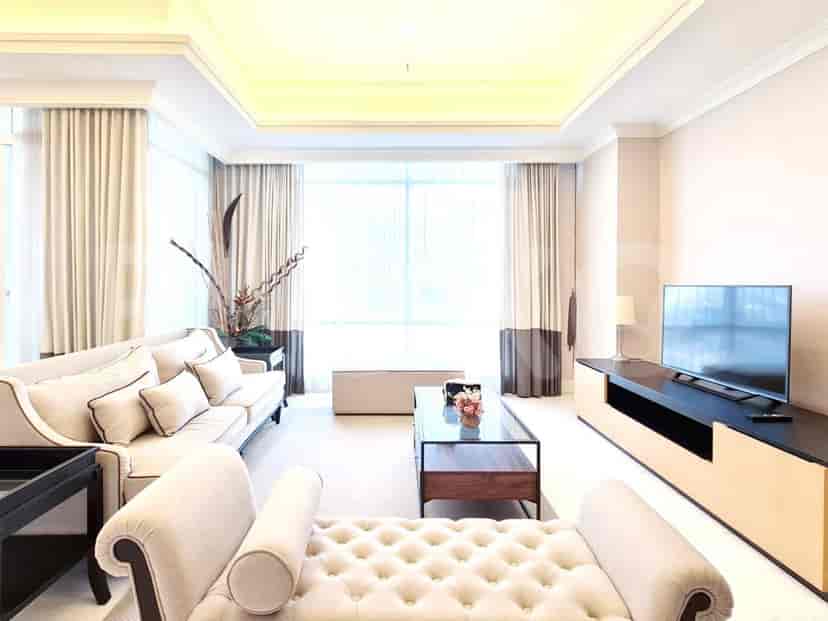 Bright living room with a neutral color palette, large windows, and contemporary furniture.
