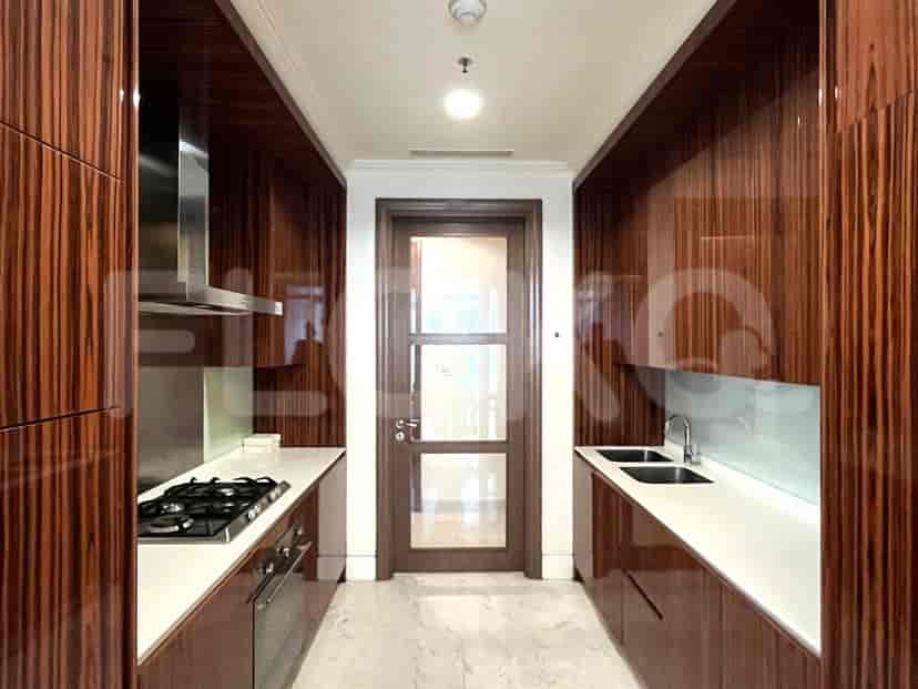Contemporary kitchen with wood cabinetry, a gas stove, and marble flooring.