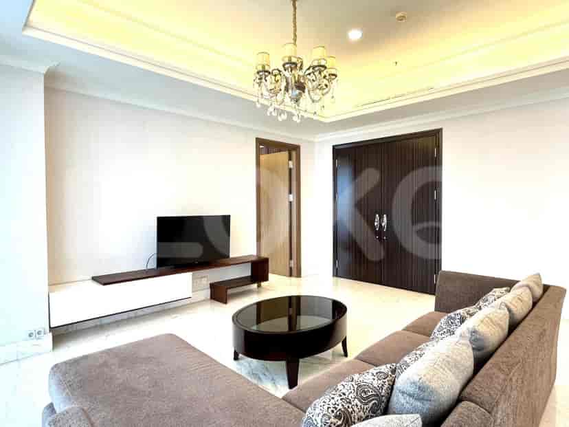 Modern living room with a low-profile TV stand, circular coffee table, and a comfortable sofa.
