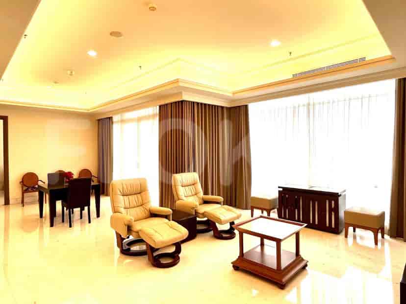 A luxurious living room featuring two recliner chairs, a dining area, and a marble floor.