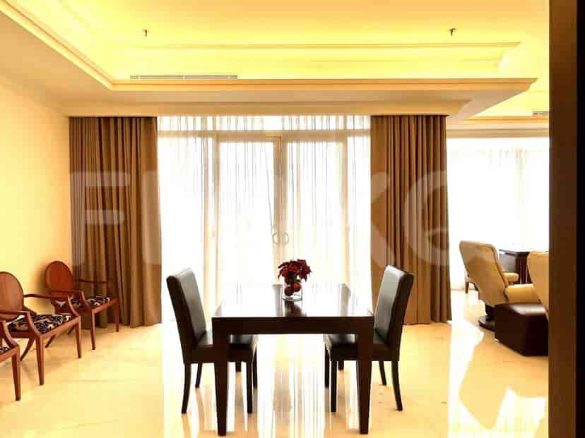 A dining area with a table, chairs and a window.