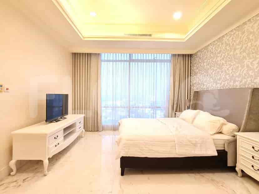 A modern bedroom with a bed, TV, and large window.