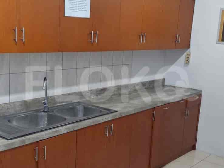 A kitchen with wooden cabinets, a sink, and a countertop.