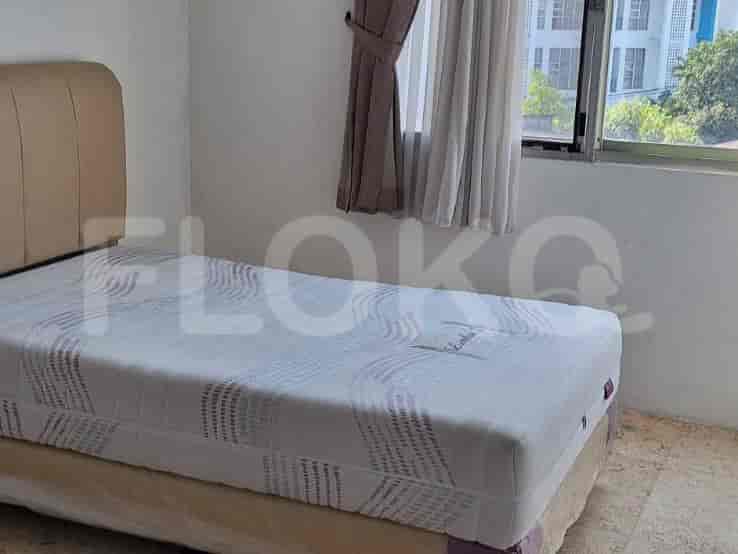 A bedroom with a single bed and curtains.