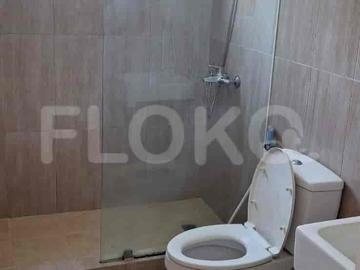 A bathroom with a shower and a toilet.