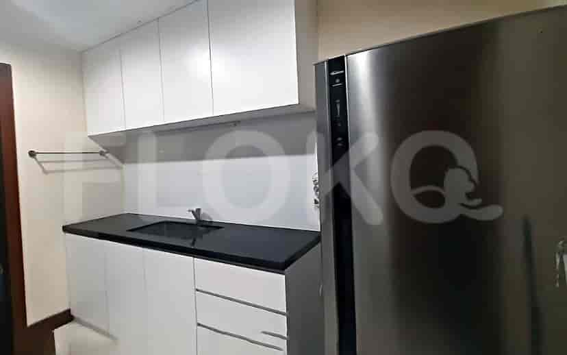 A modern kitchen with white cabinets and a black countertop.