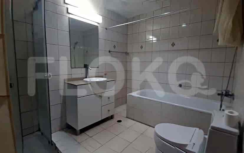A bathroom with a bathtub, a toilet, and a sink.