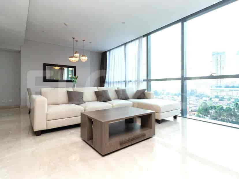 Living room with sofa, coffee table, and modern hanging lights.