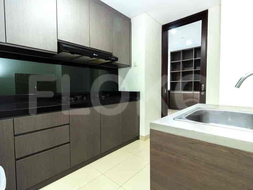 Modern kitchen with stainless steel appliances and wooden cabinets.