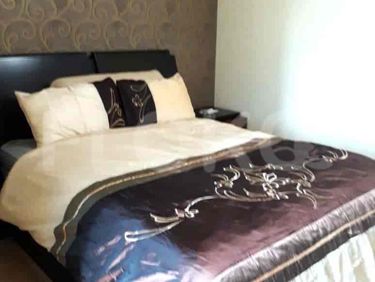 A bedroom with a bed and wall decoration.