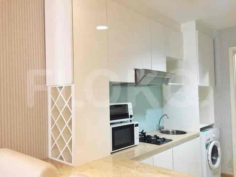 A kitchen with a microwave, sink, and cabinetry.
