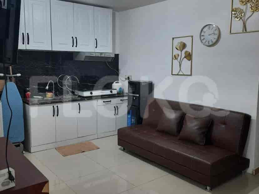 A well-equipped kitchen with white cabinets, a black countertop, and essential appliances.