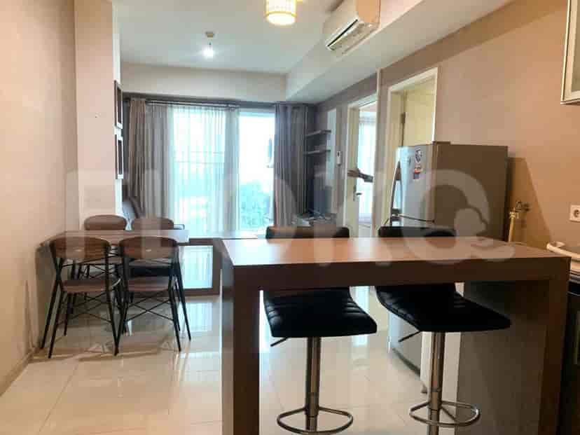 Combined living and dining space with a dining table and kitchen area.