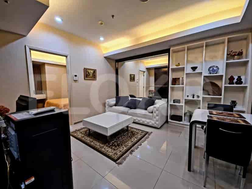 Living room with white sofa, rug, and access to other rooms.