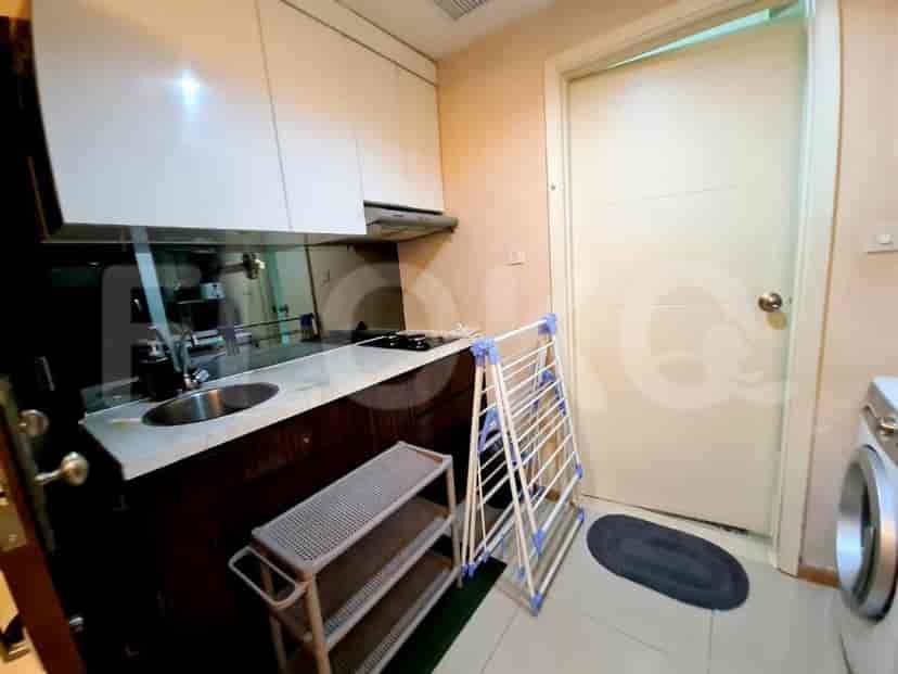 Small, functional kitchen with white cabinets and basic amenities.