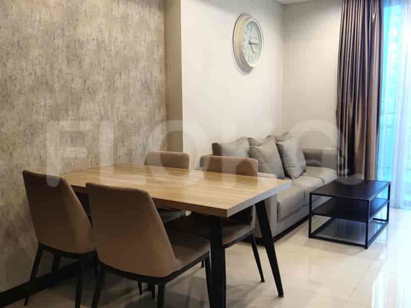 Dining area with table and chairs, near the sofa.