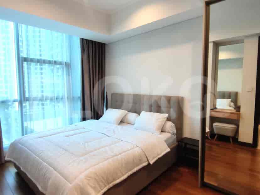 Another view of the master bedroom with a bed and windows.