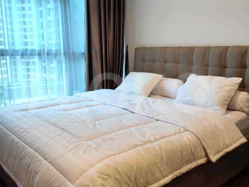 Bedroom with a bed, curtains, and a large window.