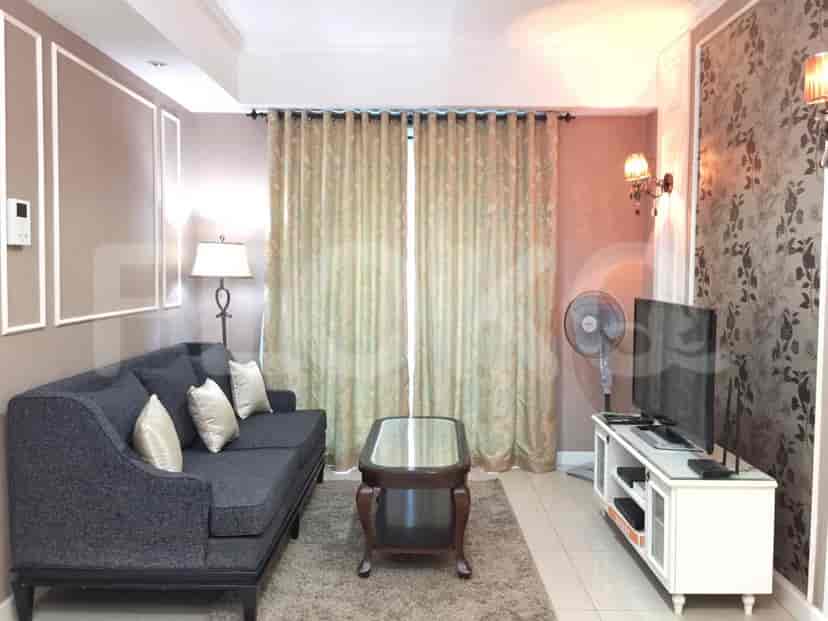 A living room with a sofa, coffee table, and television.