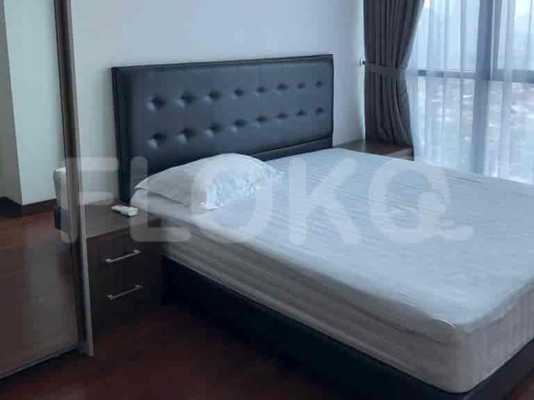 A bedroom with a bed and a nightstand.