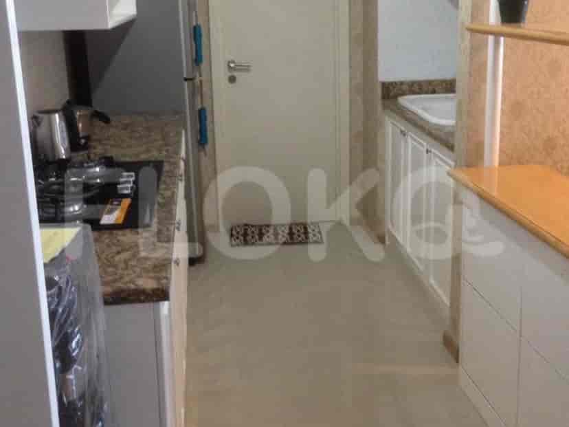 Modern kitchen with white cabinets, granite countertops, and a gas stove.