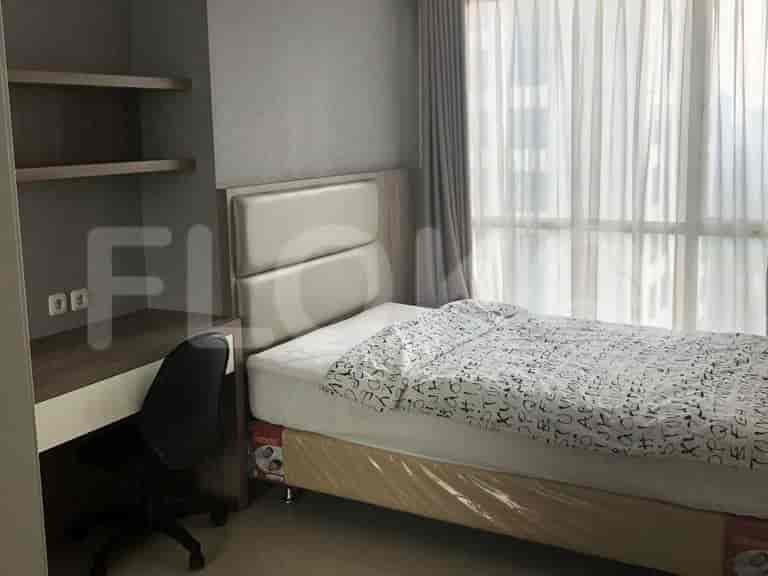 A compact bedroom with a desk area, a bed, and shelves.