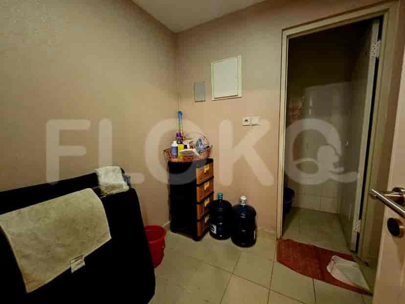 A small utility room with storage and access to the bathroom.