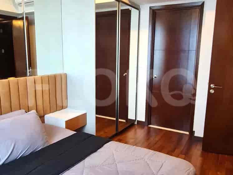 Bedroom with a bed, nightstands, and closet.