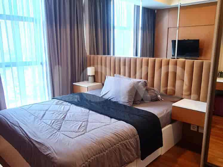 Bedroom with a bed, headboard, and curtains.