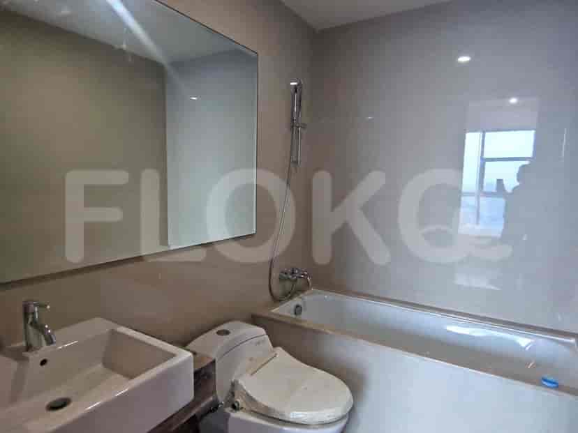 Bathroom with a bathtub, sink, and a large mirror.