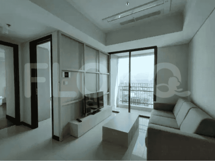 A modern living room featuring a sofa, TV, and a large window with a city view.