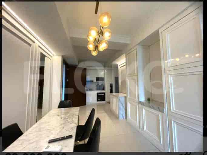 A modern kitchen with a dining table.
