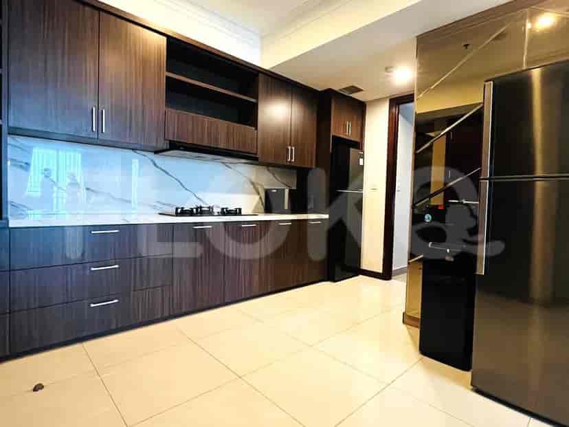 A modern kitchen with dark wooden cabinets and stainless steel appliances.