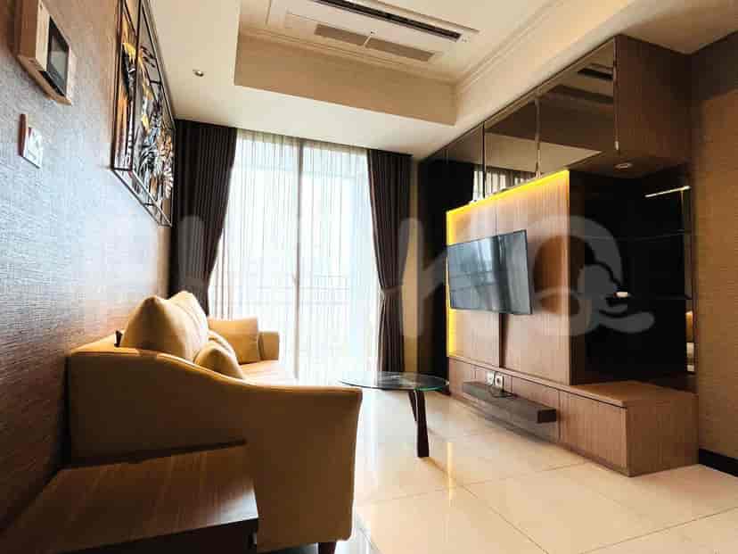 Living room view with TV and decorative wall art.