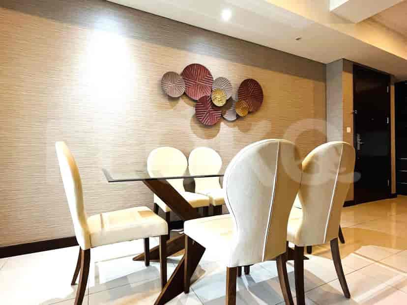 Dining area with glass table and chairs.