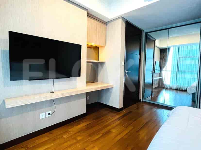 Bedroom with TV and built-in desk area.