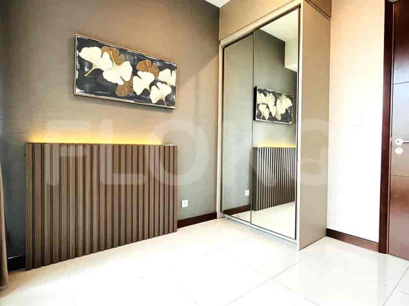 Bedroom with artwork and mirrored closet.