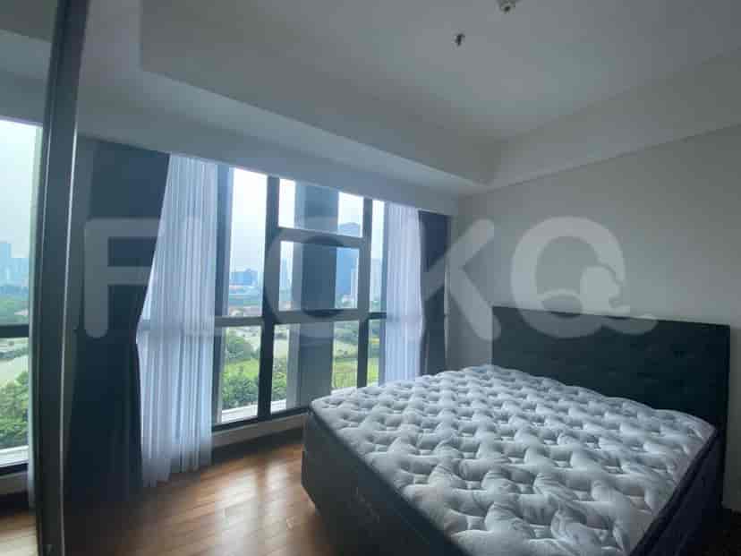 A modern bedroom with a bed, large windows, and curtains.