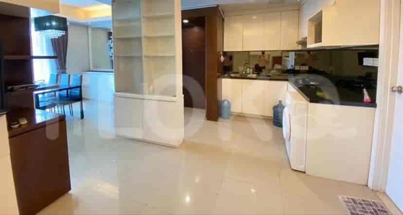 Open dining and living area with a dining table and a kitchen in the background.