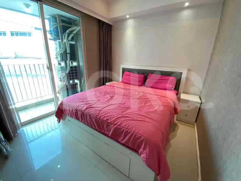 Bedroom with a bed and balcony access.