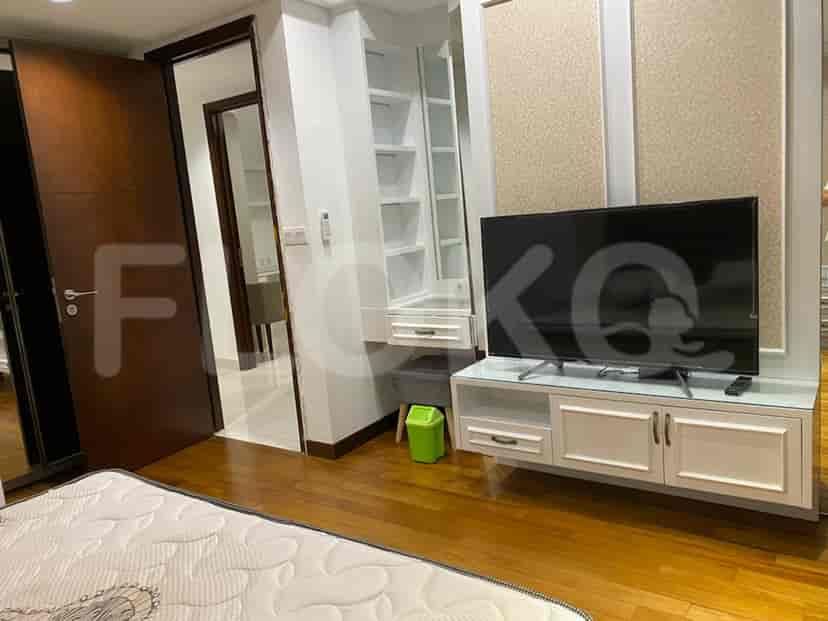 Master bedroom with a vanity and TV.