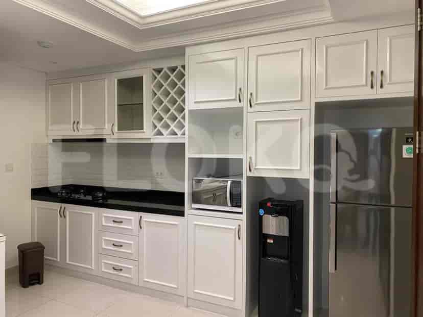 The kitchen with white cabinets and integrated appliances.