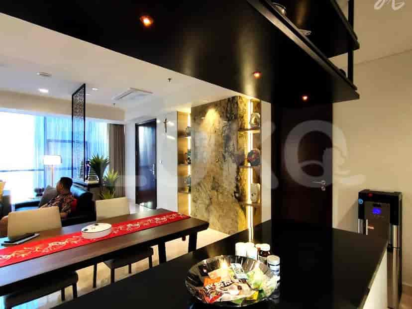 Dining area with a long table, chairs, and a black countertop.
