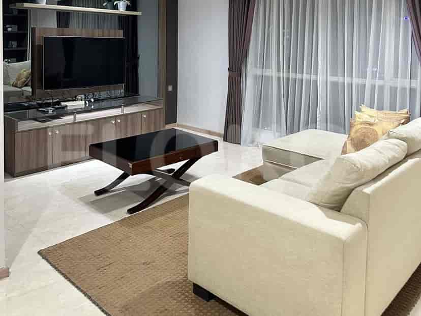 Living room with sofa, TV, and city view.