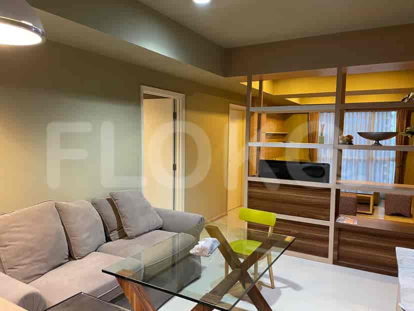 A living room with a sofa, coffee table, and built-in shelving.